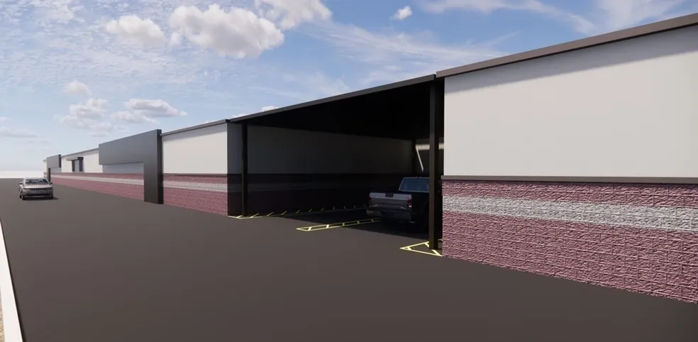 A car is parked in the garage of an industrial building.