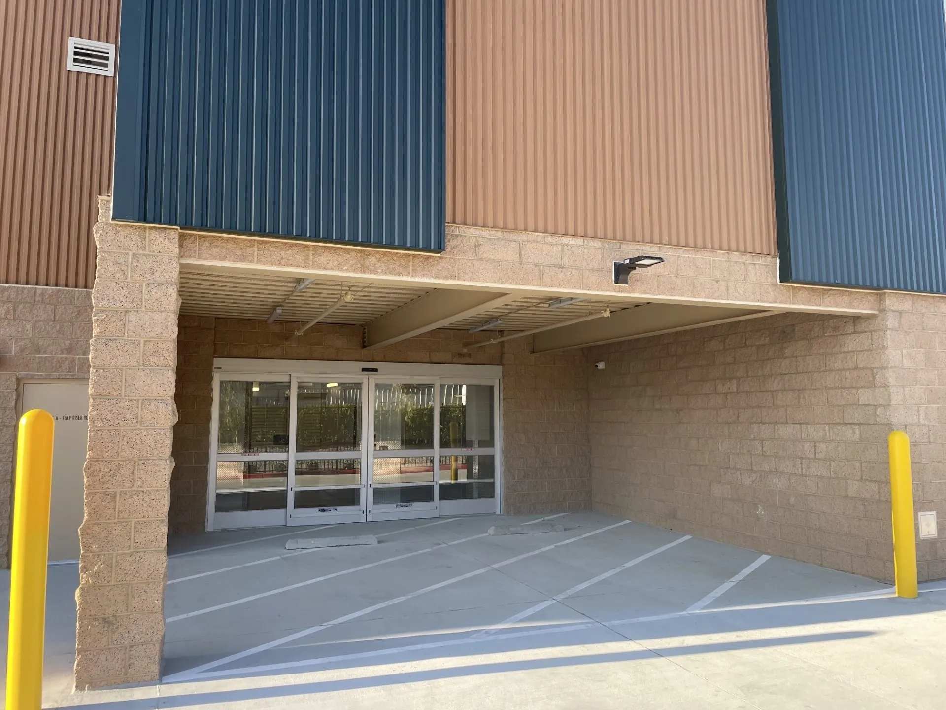 Commercial building entrance with glass doors.
