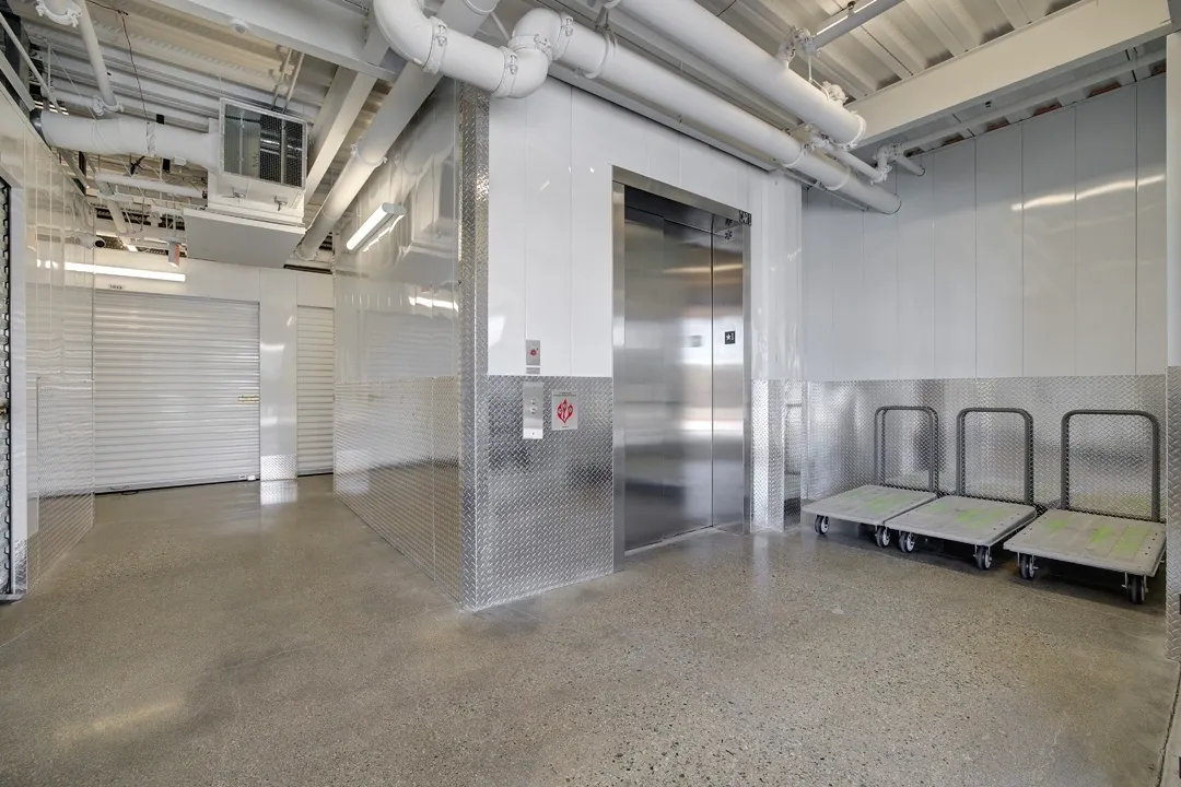 Elevator and carts in storage facility interior.