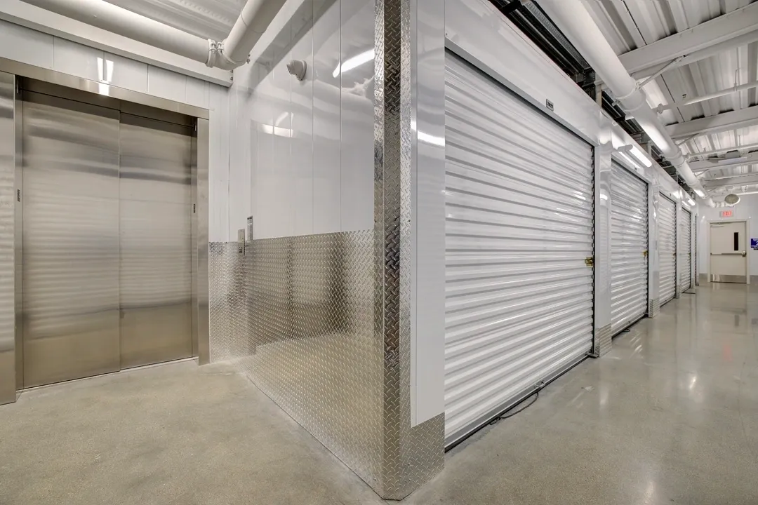 Storage facility hallway with metal doors.
