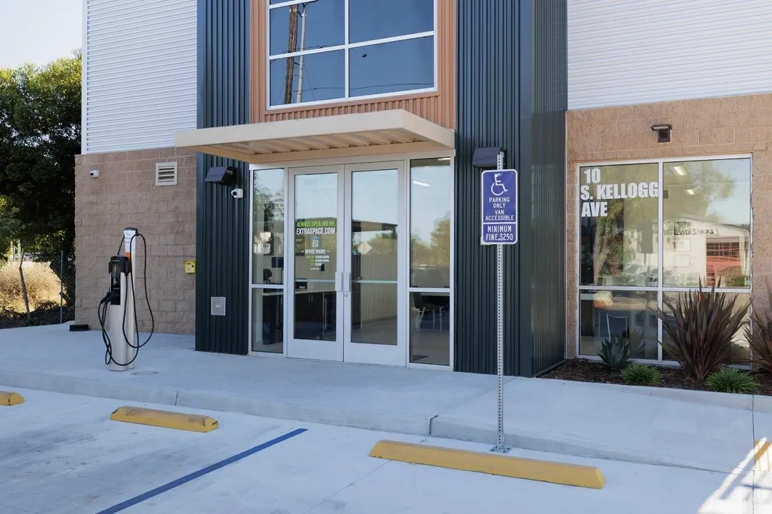 Modern building entrance with electric vehicle charger.