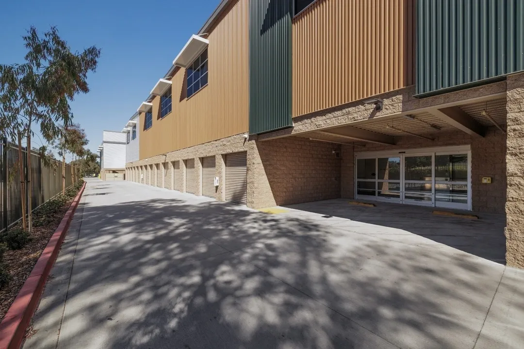 Commercial building with loading area and greenery.