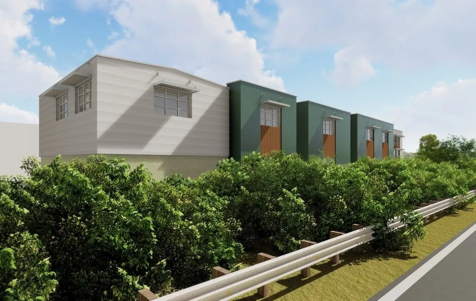 Modern buildings surrounded by greenery and road.