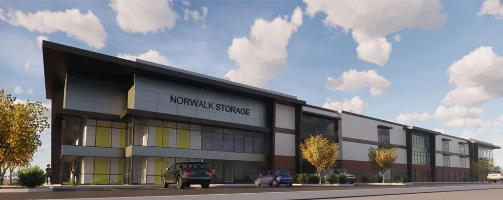 Modern storage facility with trees and clouds.