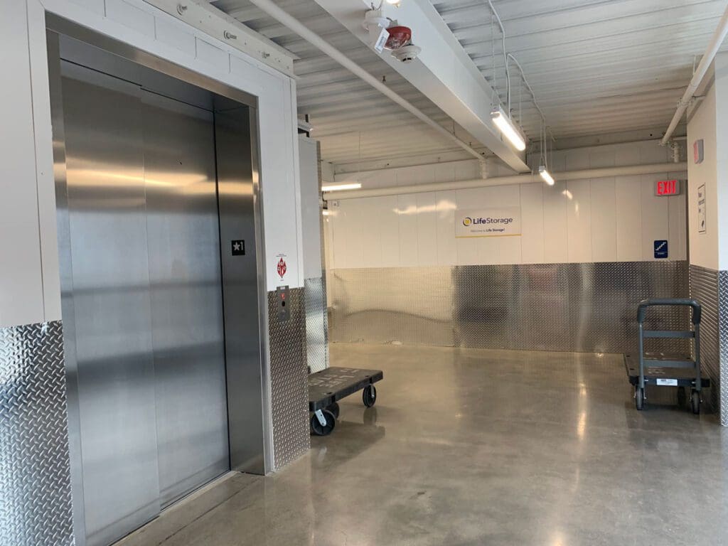 Tucson Orange Grove interior hallways with polished floors and stainless elevator door