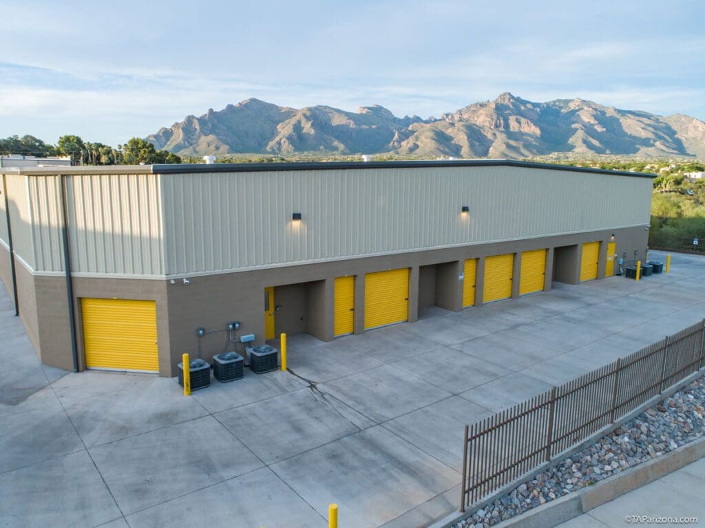 Drive-up units with yellow doors and mountains beyond