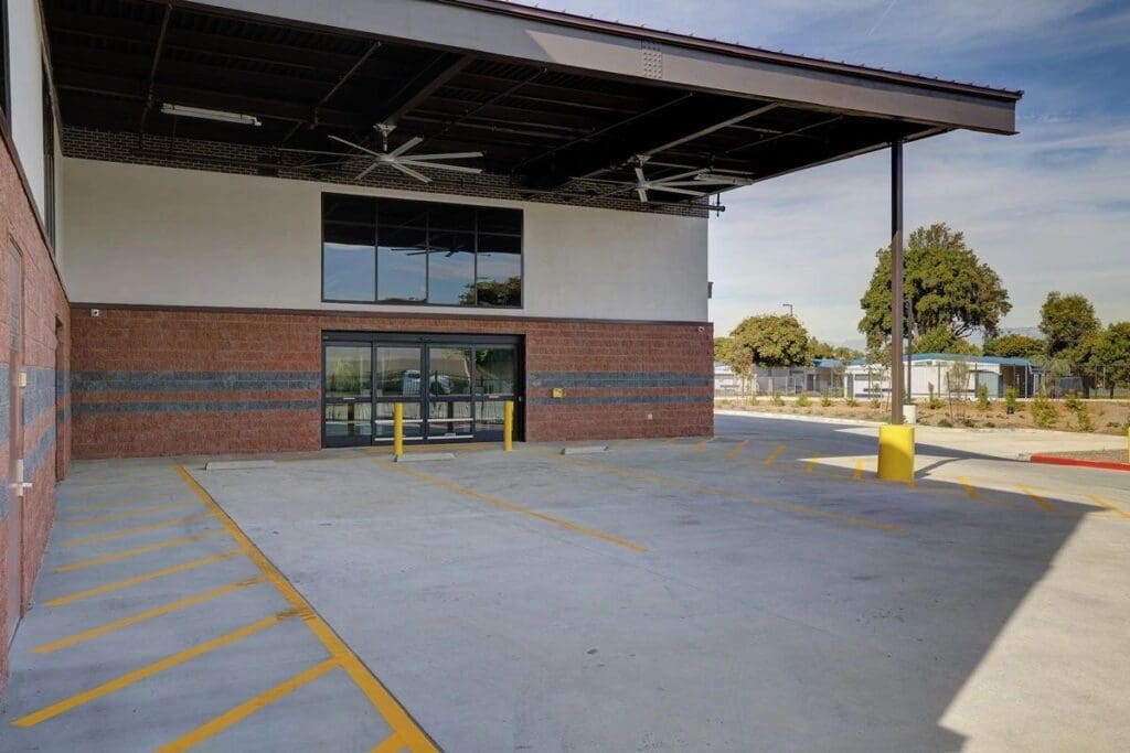 Empty parking lot in front of a building.
