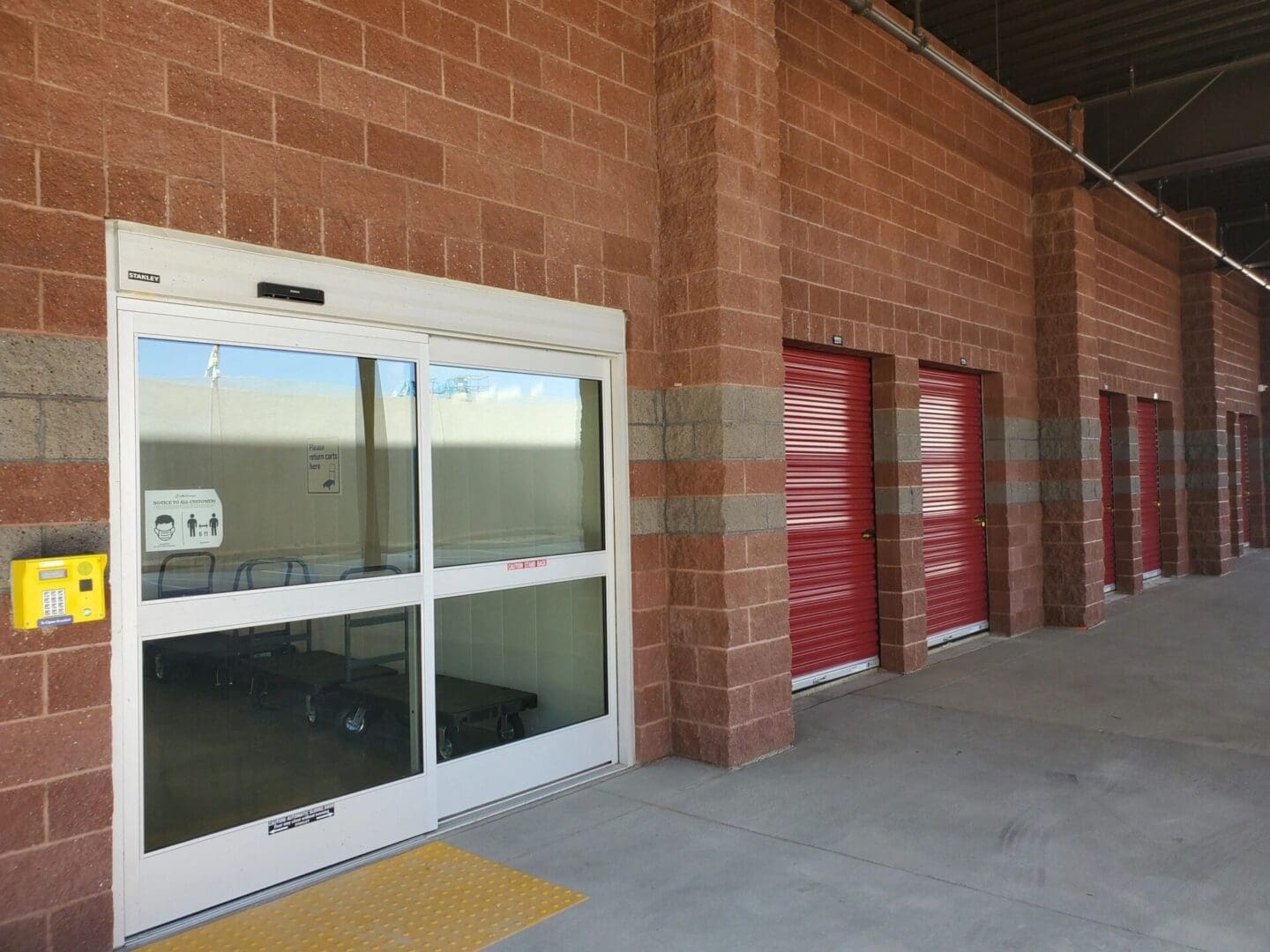 Storage building with red roll-up doors.
