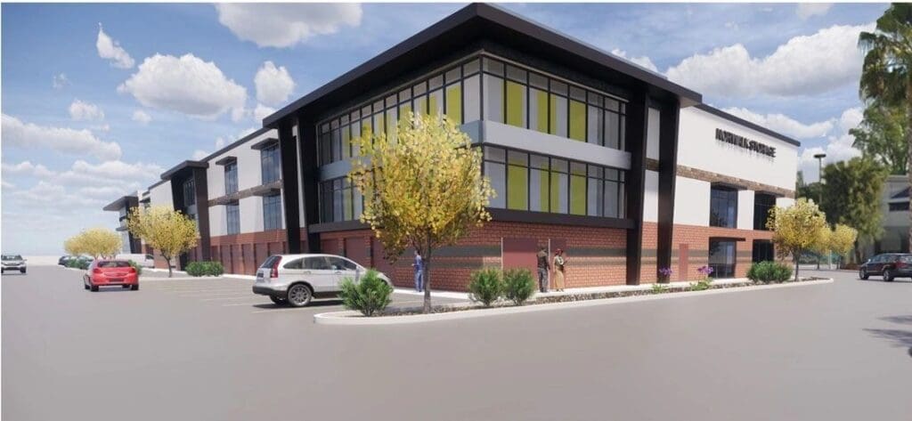 Modern building with parking lot and trees.