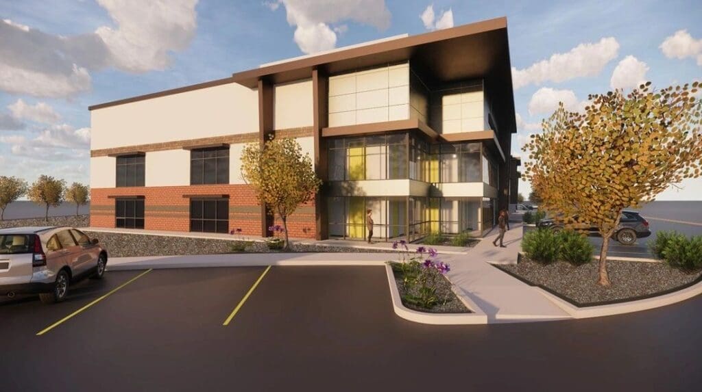 Modern building with landscaped parking area.