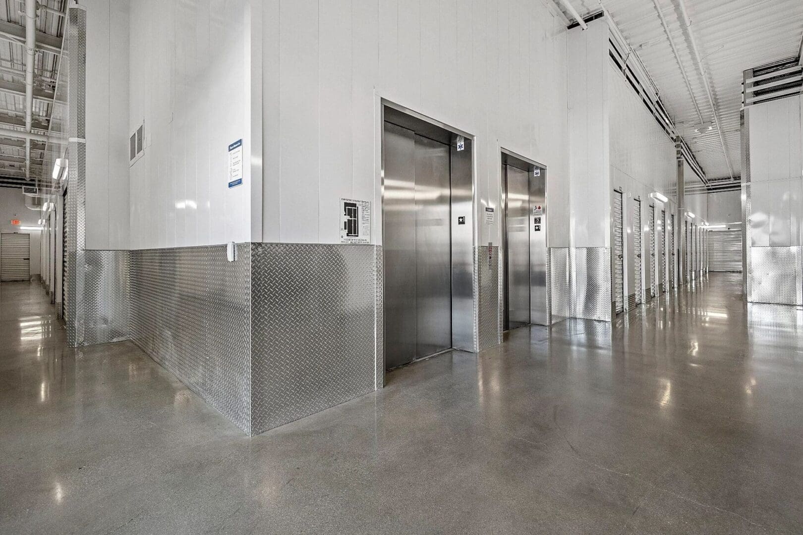 Storage facility hallway with elevators and doors.