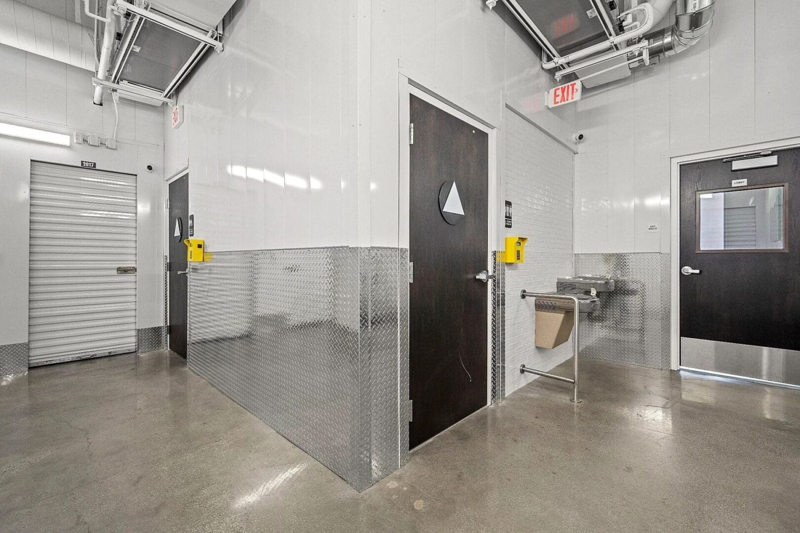 Interior hallway with doors and water fountain.