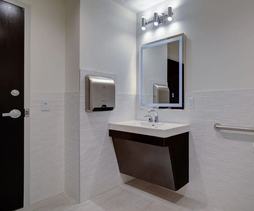 Modern restroom with sink and hand dryer.