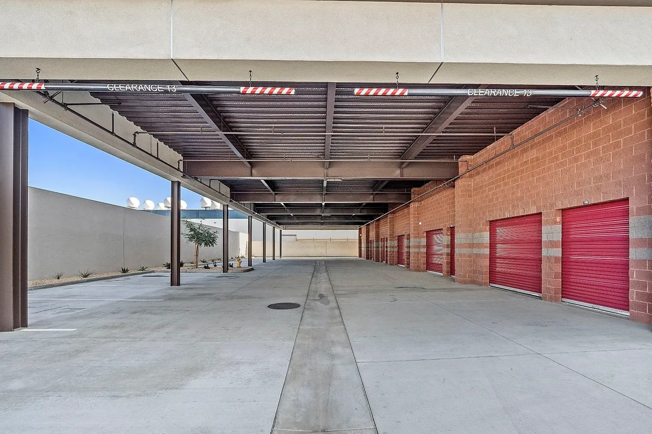 Covered parking area with storage units.
